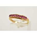 AN 18CT GOLD RUBY HALF HOOP RING, designed with row of claw set circular cut rubies, plain