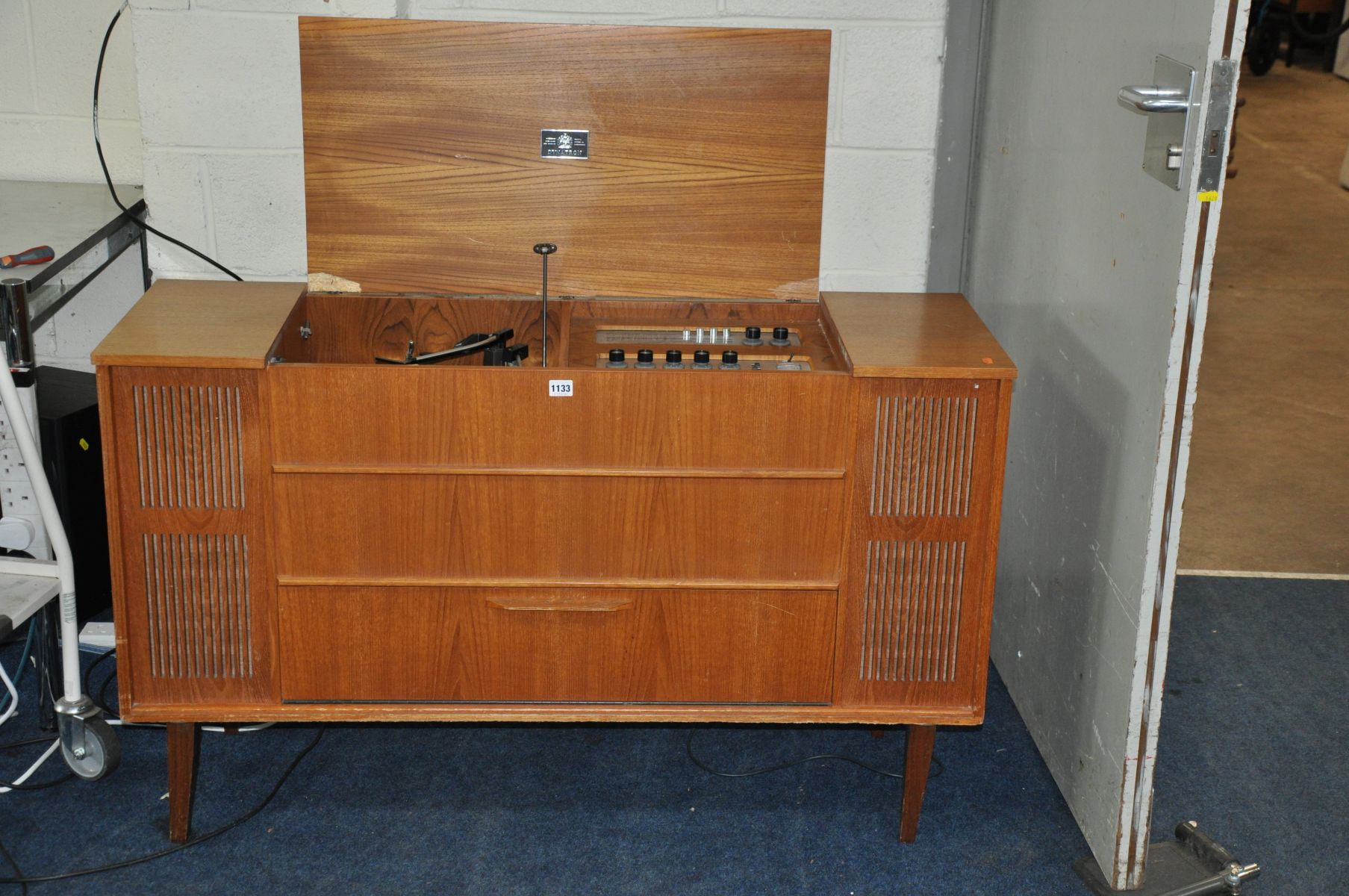 A DYNATRON 12/10 TRANSPOWER RADIOGRAM in teak case (lid broken) with a Garrard turntable, tuner (