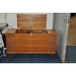 A DYNATRON 12/10 TRANSPOWER RADIOGRAM in teak case (lid broken) with a Garrard turntable, tuner (