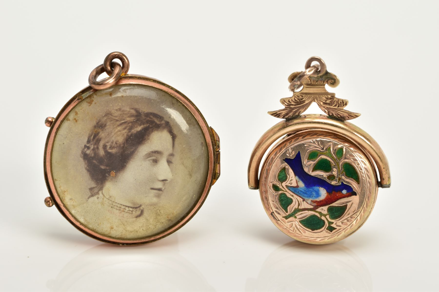 TWO YELLOW METAL LOCKETS, to include a circular double sided glass panel locket with photo, fitted