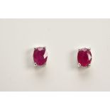 A MODERN PAIR OF 18CT WHITE GOLD RUBY SINGLE STONE STUD EARRINGS, rubies measuring approximately 5.