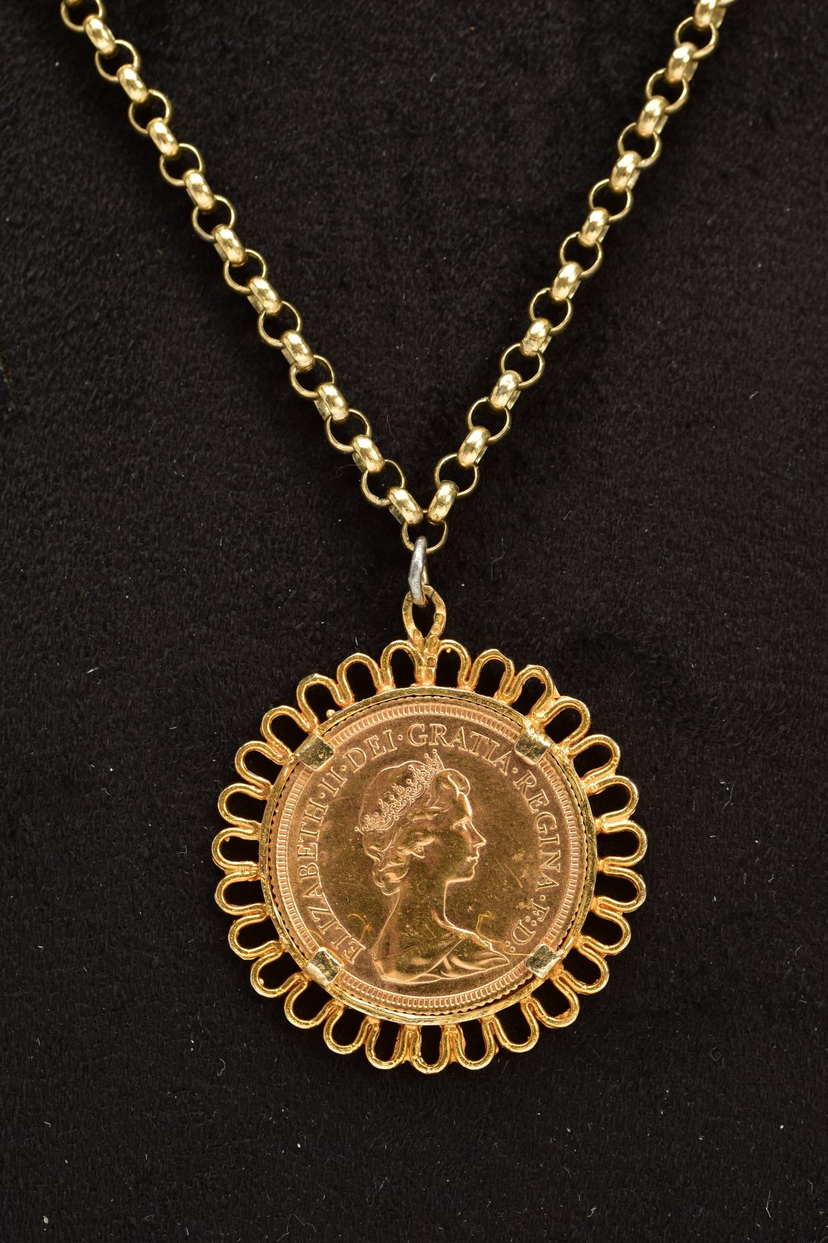 A 1979 FULL SOVEREIGN MOUNTED AS A PENDANT ON CHAIN, within a collet mount and scallop edge