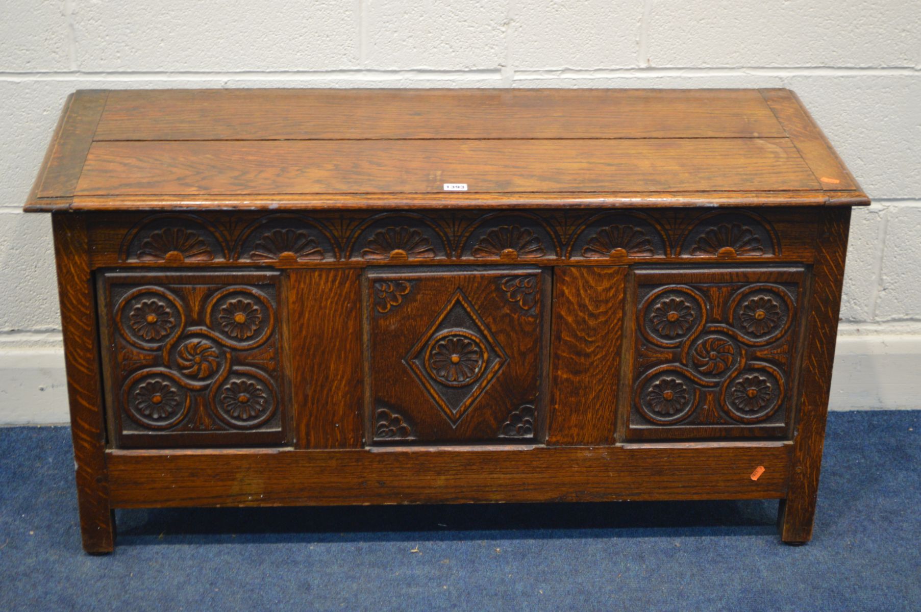 AN EARLY 20TH CENTURY BLANKET CHEST, with a lunette detail frieze above a triple panel front bearing