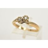 A 9CT GOLD DIAMOND RING, of crossover design set with two round brilliant cut diamonds, single cut
