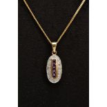 A 9CT GOLD AMETHYST AND DIAMOND PENDANT NECKLACE, the oval pendant designed with a central row of