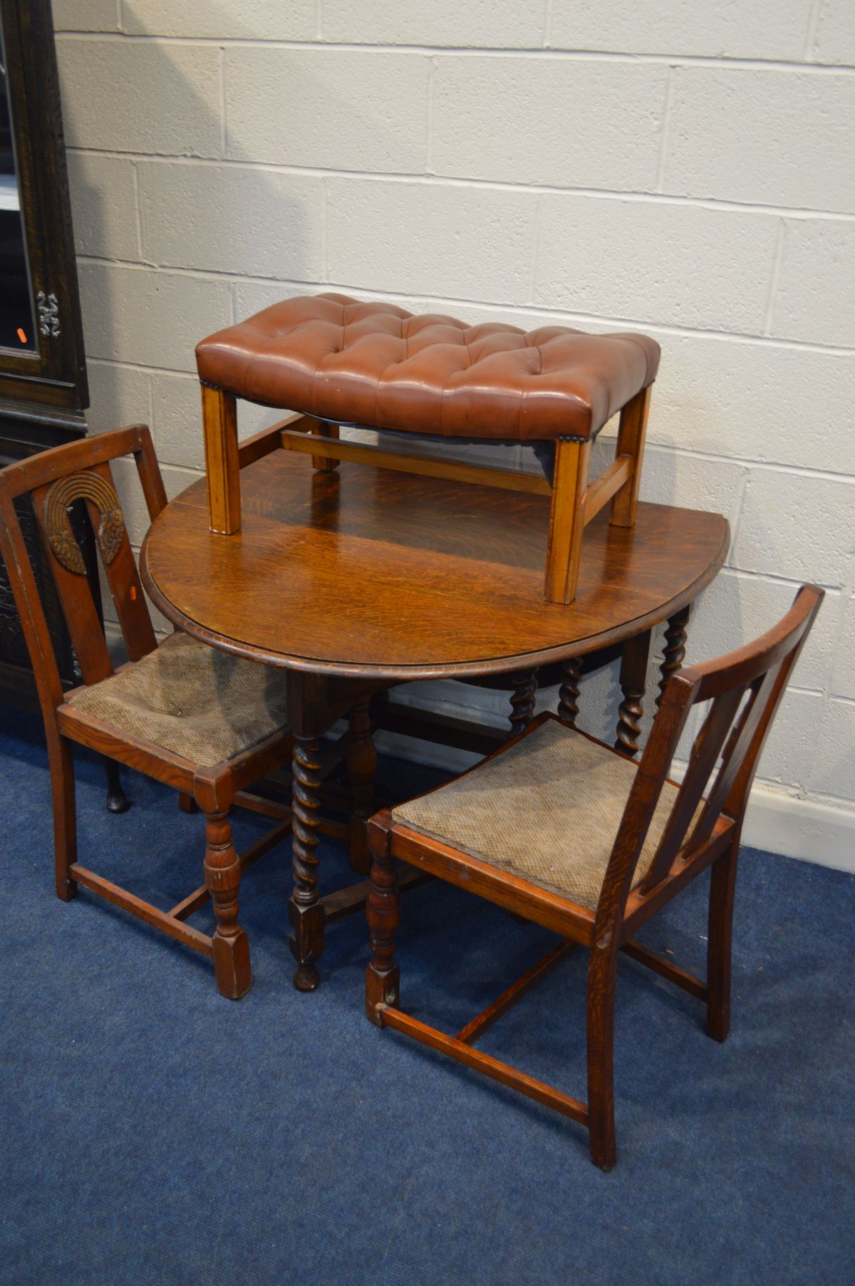 AN OAK BARLEY TWIST DROP LEAF TABLE, four chairs (sd) a brown buttoned leather footstool on an oak - Image 3 of 4
