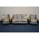 AN EARLY TO MID 20TH CENTURY OAK FRAMED BERGERE THREE PIECE SUITE, the frame with outsplayed
