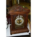 AN OAK CASED BRACKET CLOCK having a brass dia with painted chapter ring, Junghans movement, runs