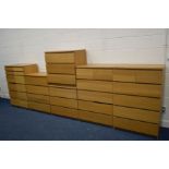 A SET OF SEVEN MATCHING OAK FINISH CHEST OF DRAWERS, of various sizes, to include two chest or two