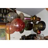 FIVE VARIOUS VICTORIAN/EDWARDIAN OIL LAMPS, including an example with frosted and clear globe shade,