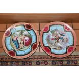 A PAIR OF VIENNA PORCELAIN CHARGERS, depicting classical scenes of cherubs, soldier, lovers etc,