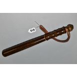AN UNMARKED WOODEN TRUNCHEON, with leather wrist strap to handle, some marking and wear mainly to