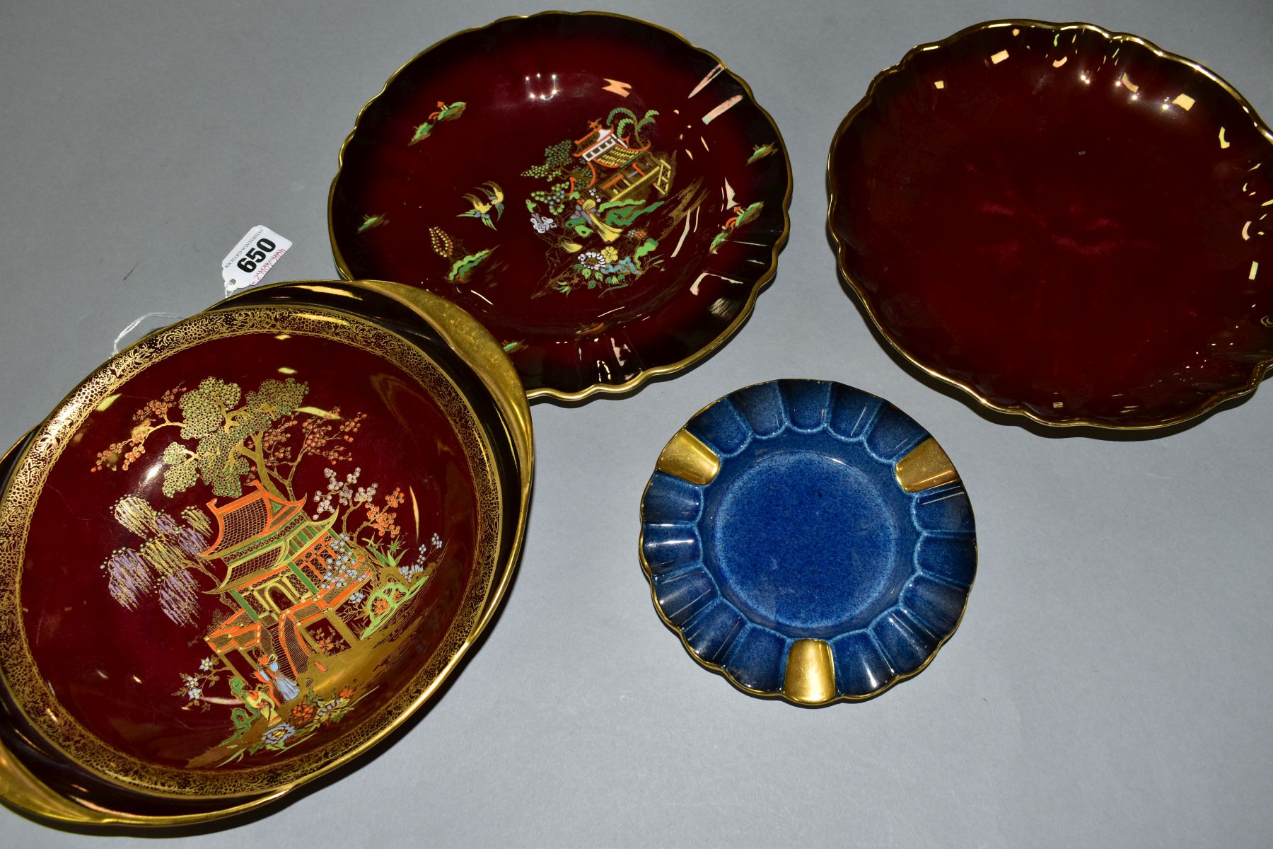 A CARLTON WARE ROUGE ROYALE TWIN HANDLED BOWL, a Carlton Ware powder blue ashtray, another Carlton