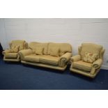 A LEE LONGLANDS THREE PIECE LOUNGE SUITE, with gold and spotted red upholstery, on brass casters,