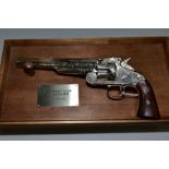 A BOXED FRANKLIN MINT WYATT EARP .44 REVOLVER, on a wooden display stand, with paperwork, appears