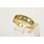 AN 18CT GOLD EMERALD AND DIAMOND HALF HOOP RING, designed with four claw set emeralds interspaced