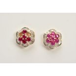 A NEAR PAIR OF 9CT GOLD RUBY AND DIAMOND EARRINGS, each designed as a cluster set with near matching