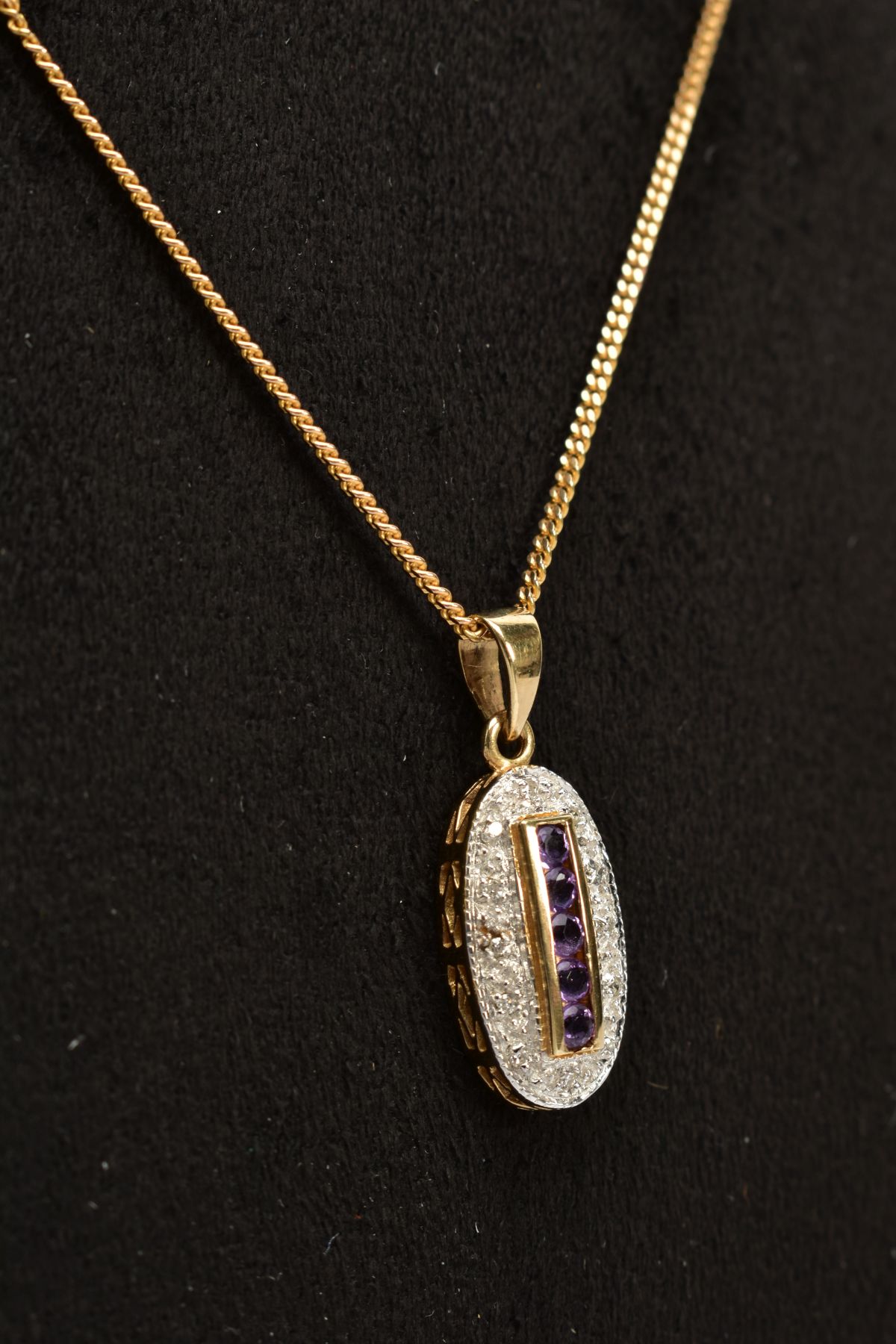 A 9CT GOLD AMETHYST AND DIAMOND PENDANT NECKLACE, the oval pendant designed with a central row of - Image 2 of 3