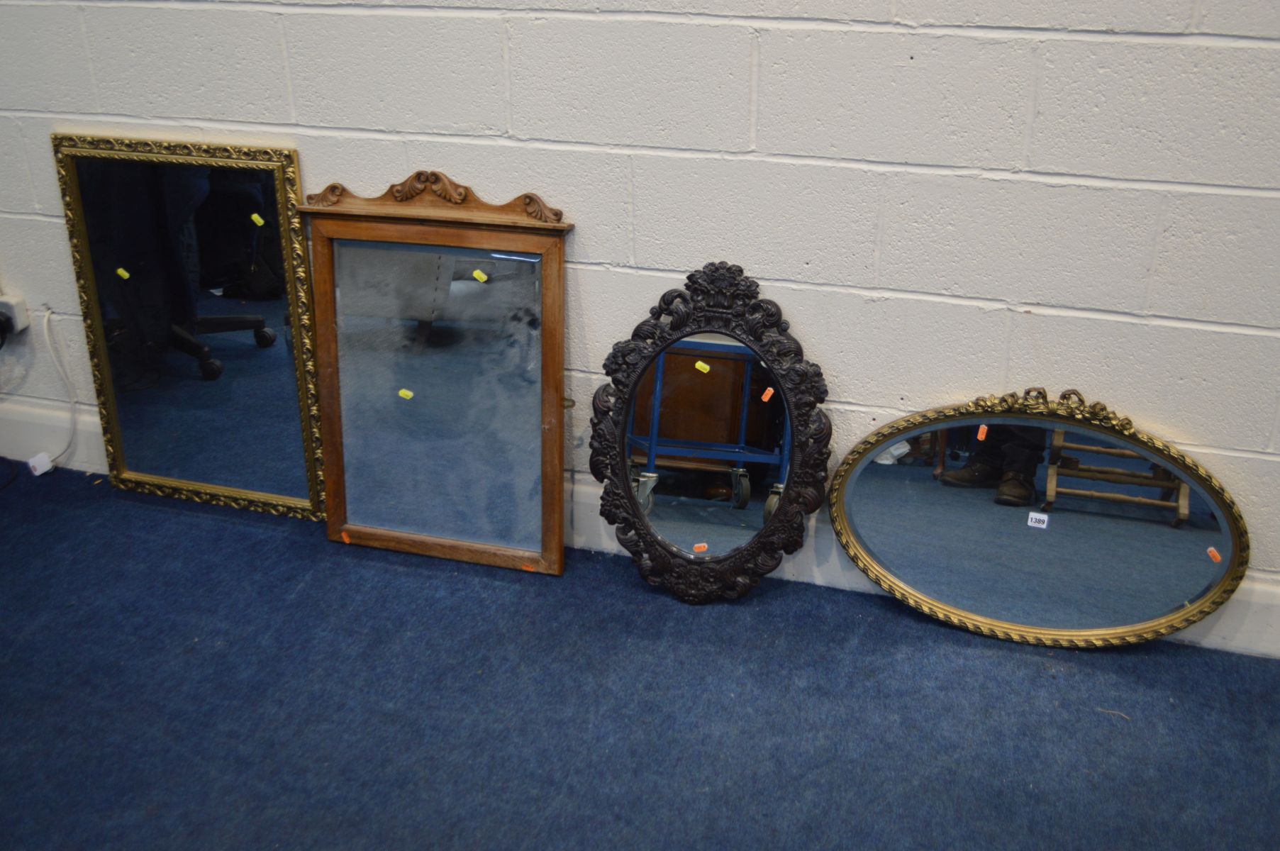 A MODERN GILT FRAMED OVAL WALL MIRROR, together with a carved ebonised wood wall mirror and two