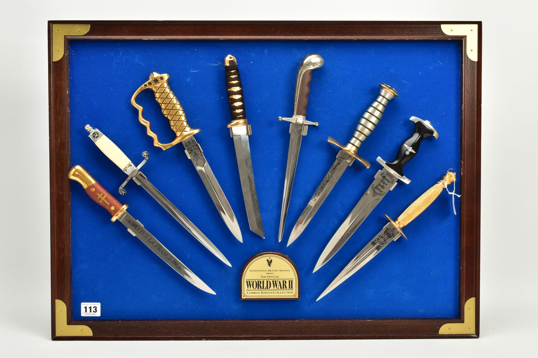 A LARGE FRAME DISPLAY OF COMBAT KNIVES OF WWII, eight knives and daggers in total, display use