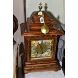 AN EARLY 20TH CENTURY GERMAN WALNUT CASED BRACKET CLOCK, the caddy hood with gilt metal mounts, gilt