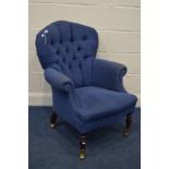 A MODERN BLUE UPHOLSTERED BUTTONBACK ARMCHAIR, on brass casters (no fire label present so not to