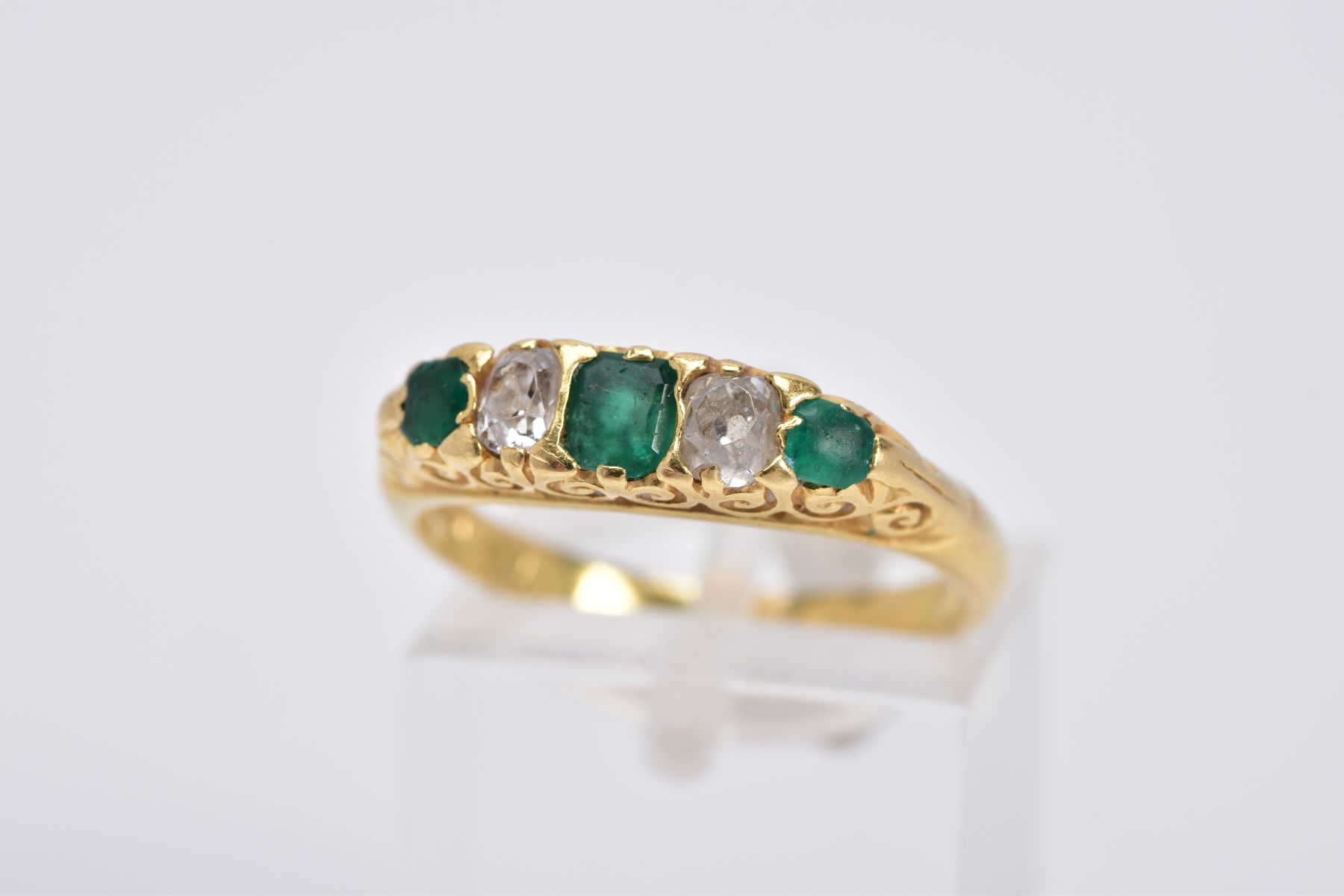 AN EARLY 20TH CENTURY EMERALD AND DIAMOND RING, designed with a central emerald cut emerald