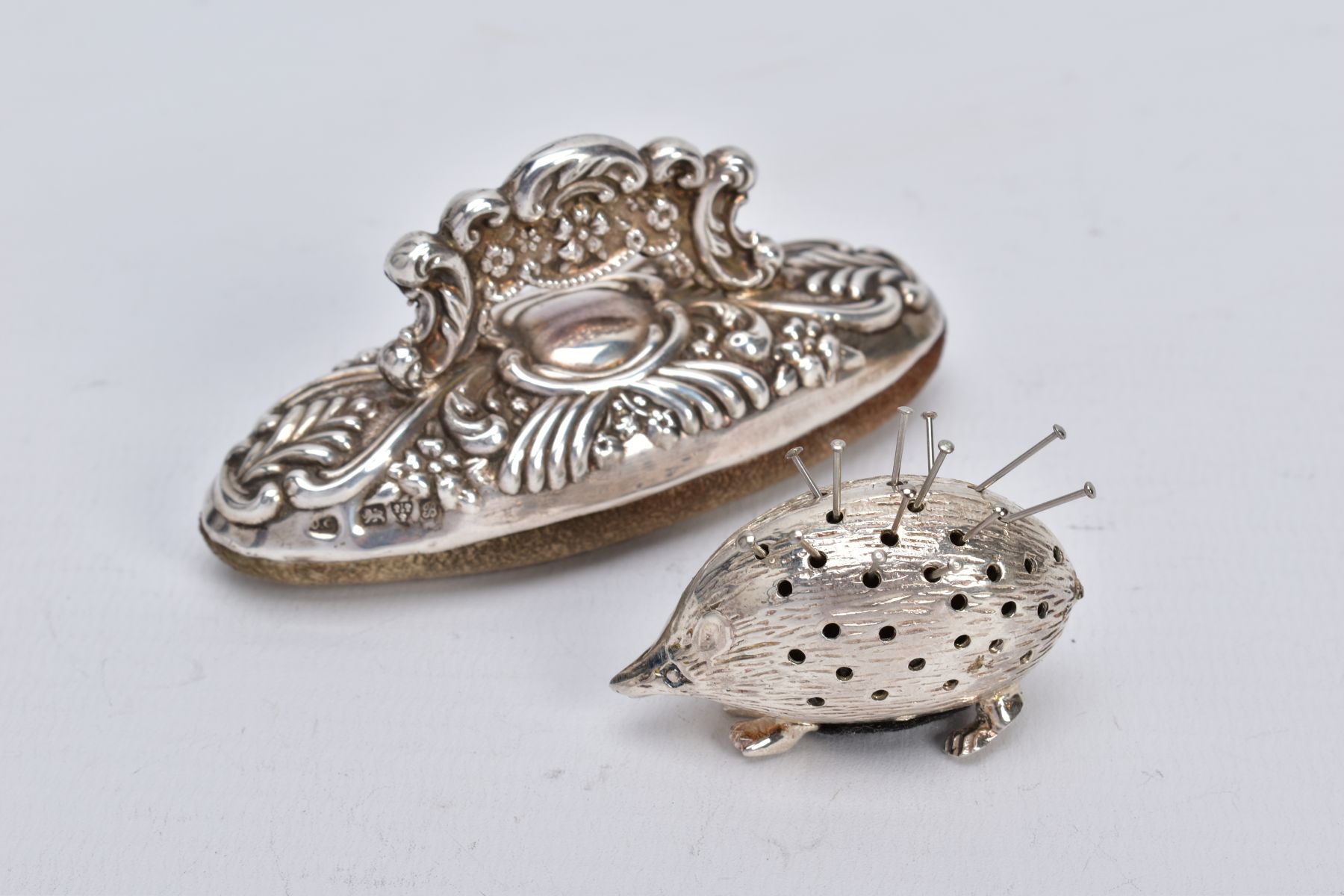 A SILVER PIN CUSHION AND NAIL BUFFER, the pin cushion on the form of a hedgehog, hallmarked