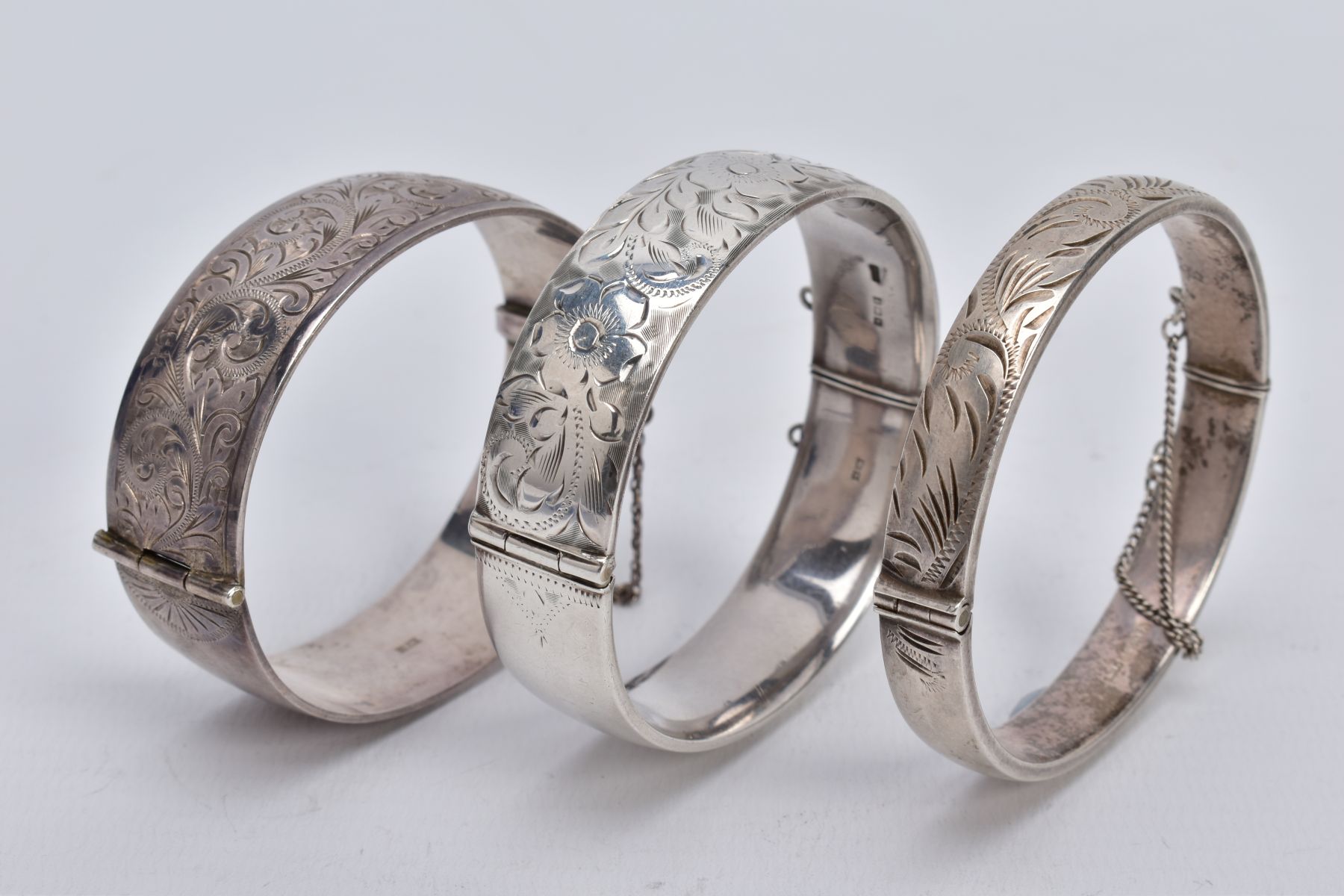 THREE SILVER HINGED BANGLES, the first a wide bangle with a foliate engrave design, push pin clasp - Image 3 of 3