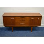 A 1970'S/80'S TEAK SIDEBOARD, with cupboard doors flanking three drawers, on tapering legs, width