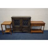 AN OAK LEAD GLAZED TWO DOOR BOOKCASE, together with an oak tea trolley with a single drawer and