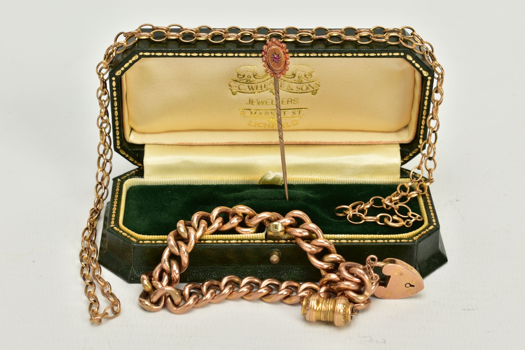 A 9CT GOLD CHARM BRACELET, A 9CT GOLD FINE BELCHER CHAIN AND A STICKPIN, an early 20th century charm