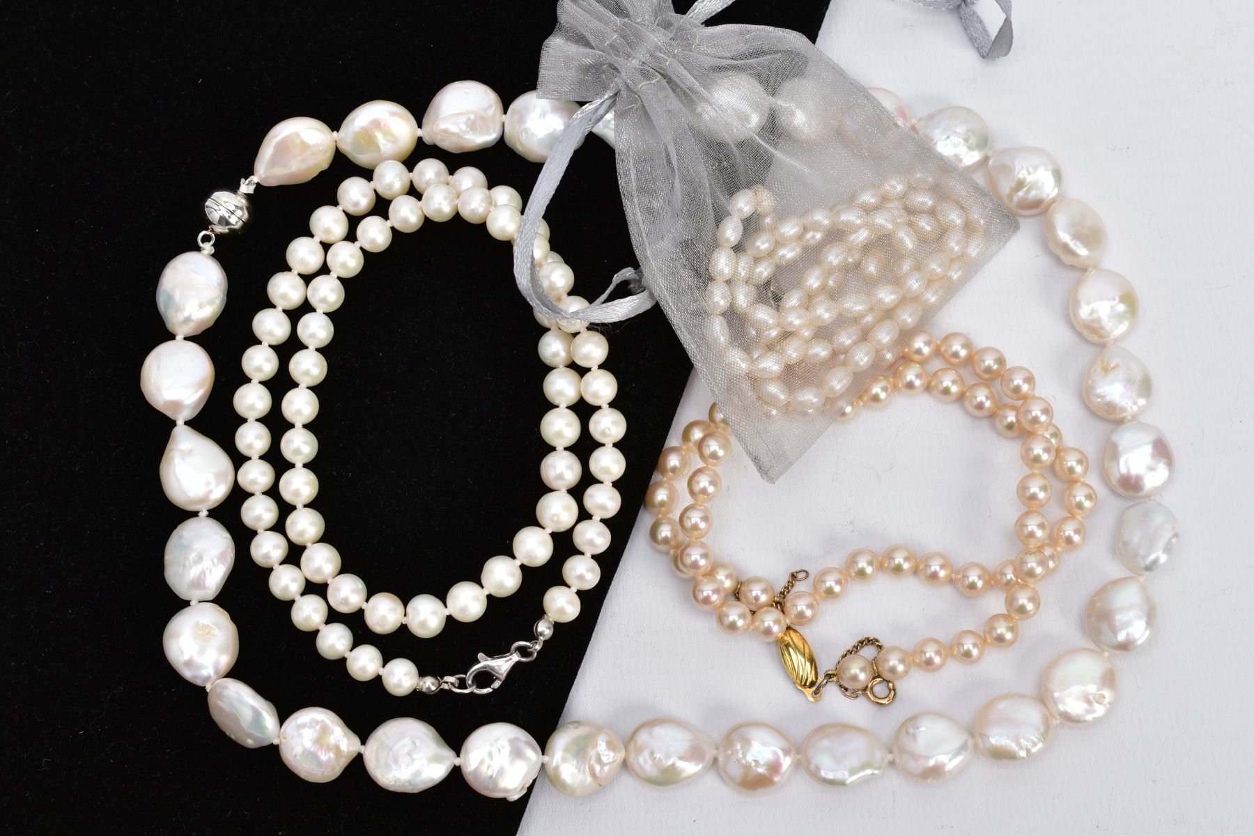 A SELECTION OF CULTURED AND IMITATION PEARL STRAND NECKLACES, the first strand of small baroque