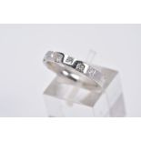 A PLATINUM DIAMOND RING, a half hoop design, set with row of six princess cut diamonds, total