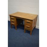 A MID 20TH CENTURY LIGHT OAK DESK with five various drawers, width 121cm x depth 76cm x height