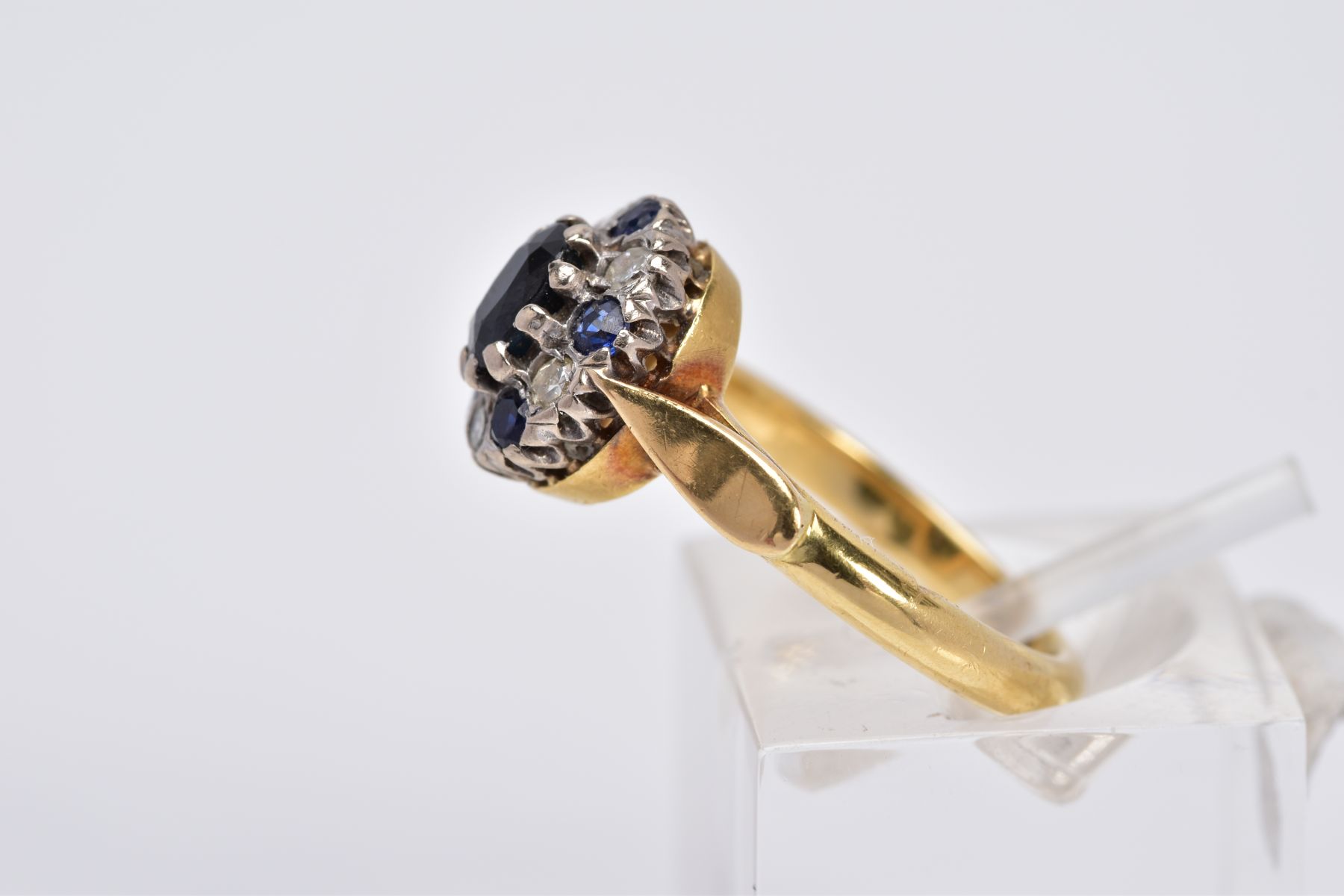 A SAPPHIRE AND DIAMOND CLUSTER RING, of tiered design set with a central oval cut sapphire, within a - Image 2 of 3