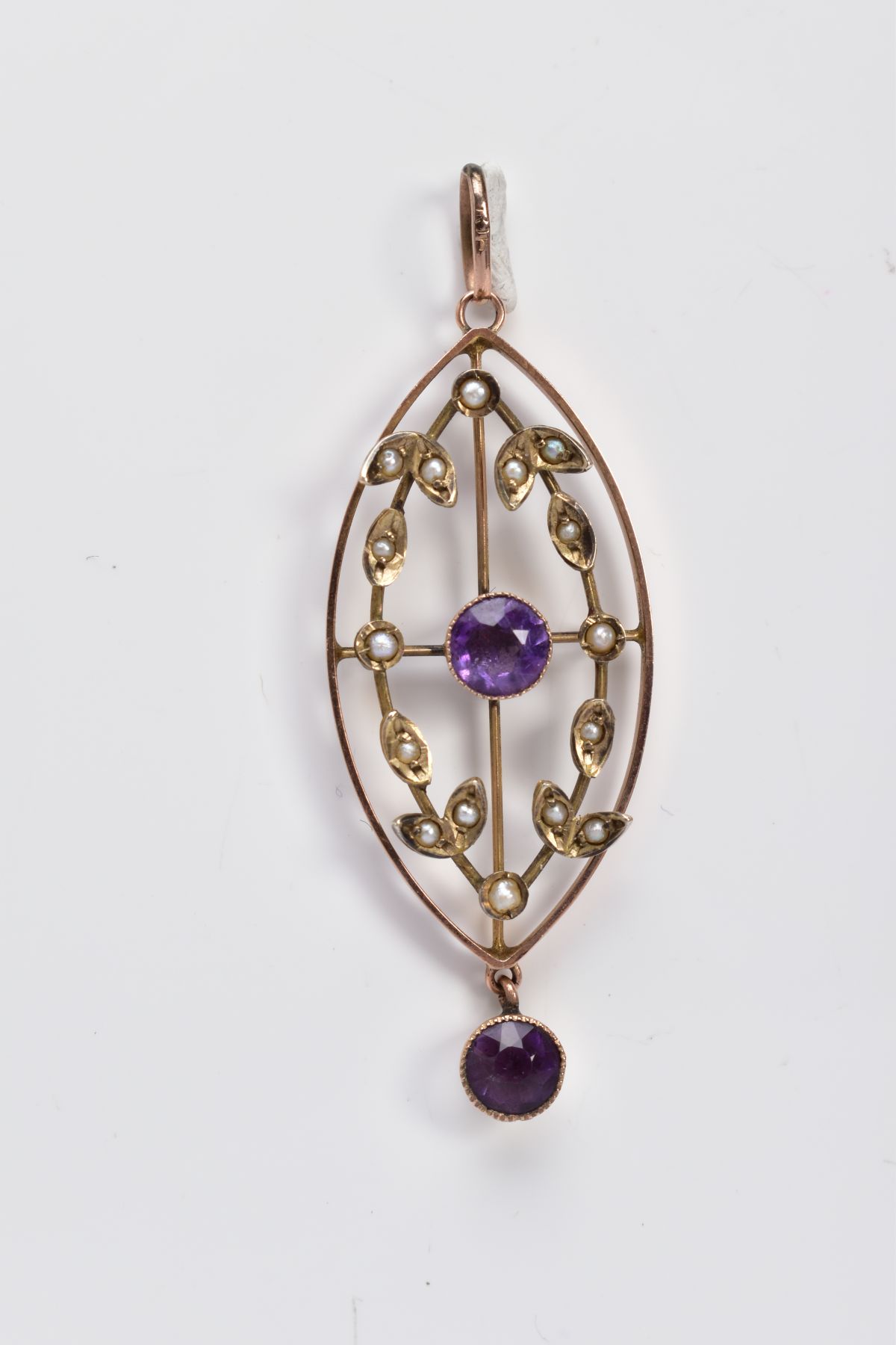 AN EDWARDIAN OPENWORK PENDANT, the rose gold coloured pendant of oval form, set with a central