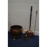 A COPPER CIRCULAR LOG BUCKET, with twin brass handles on triple legs, diameter 40cm x height 35cm