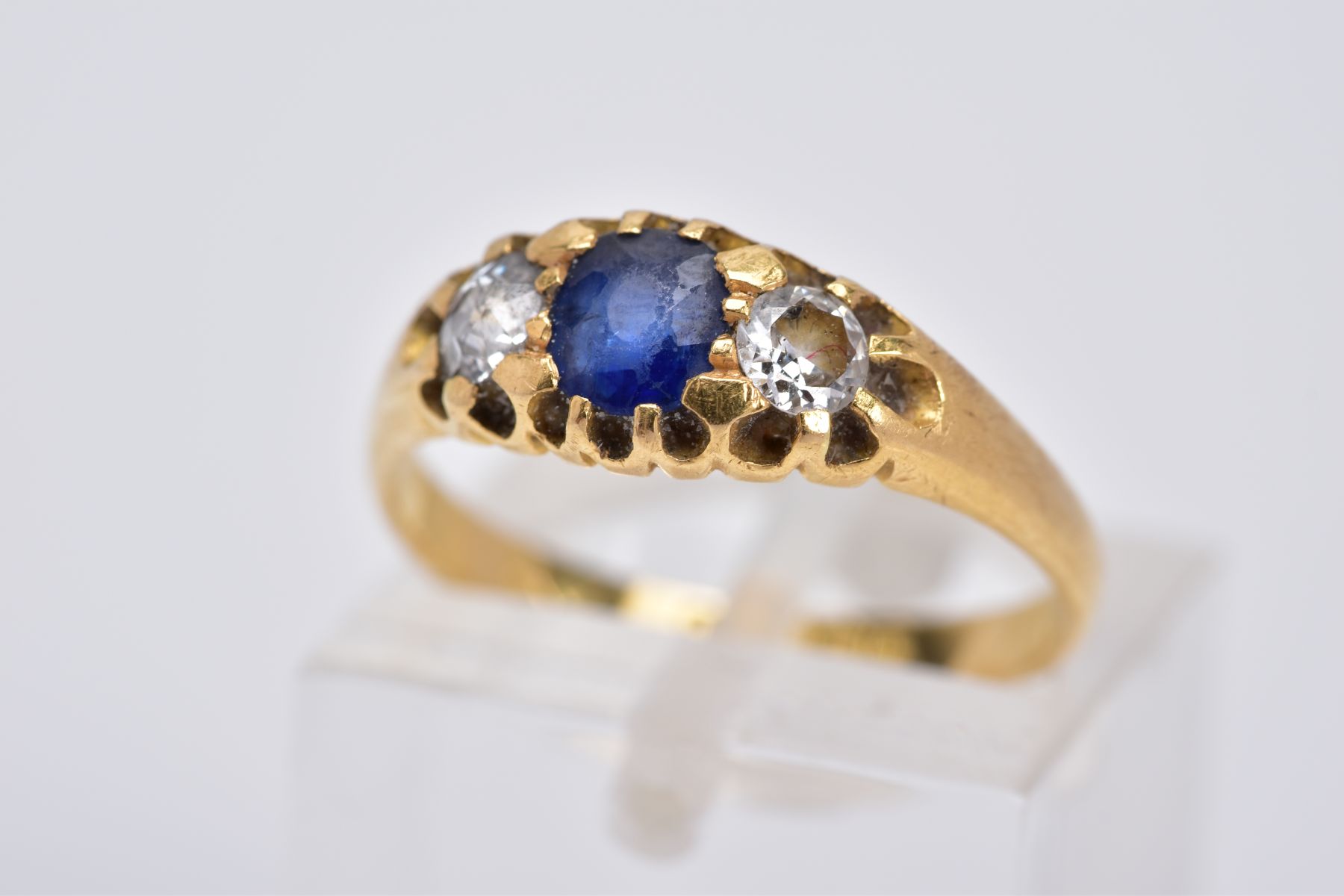 AN 18CT GOLD EARLY 20TH CENTURY SAPPHIRE AND DIAMOND RING, designed with a central oval cut blue