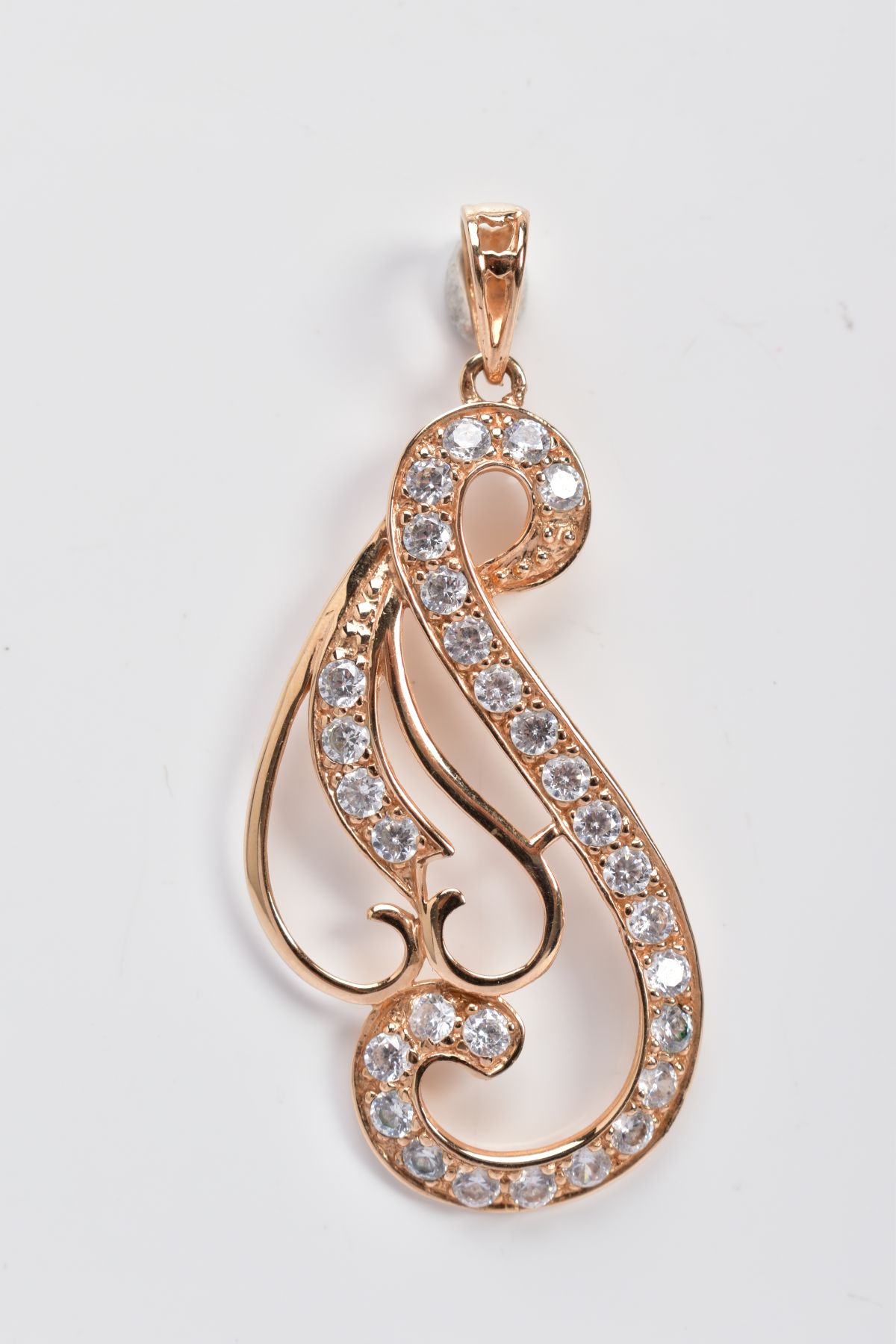 A YELLOW METAL OPENWORK PENDANT, of scroll design, embellished with circular cut cubic zirconia,