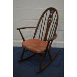 A DARK ERCOL ASH SWAN BACK WINDSOR ROCKING CHAIR with a removable seat pad
