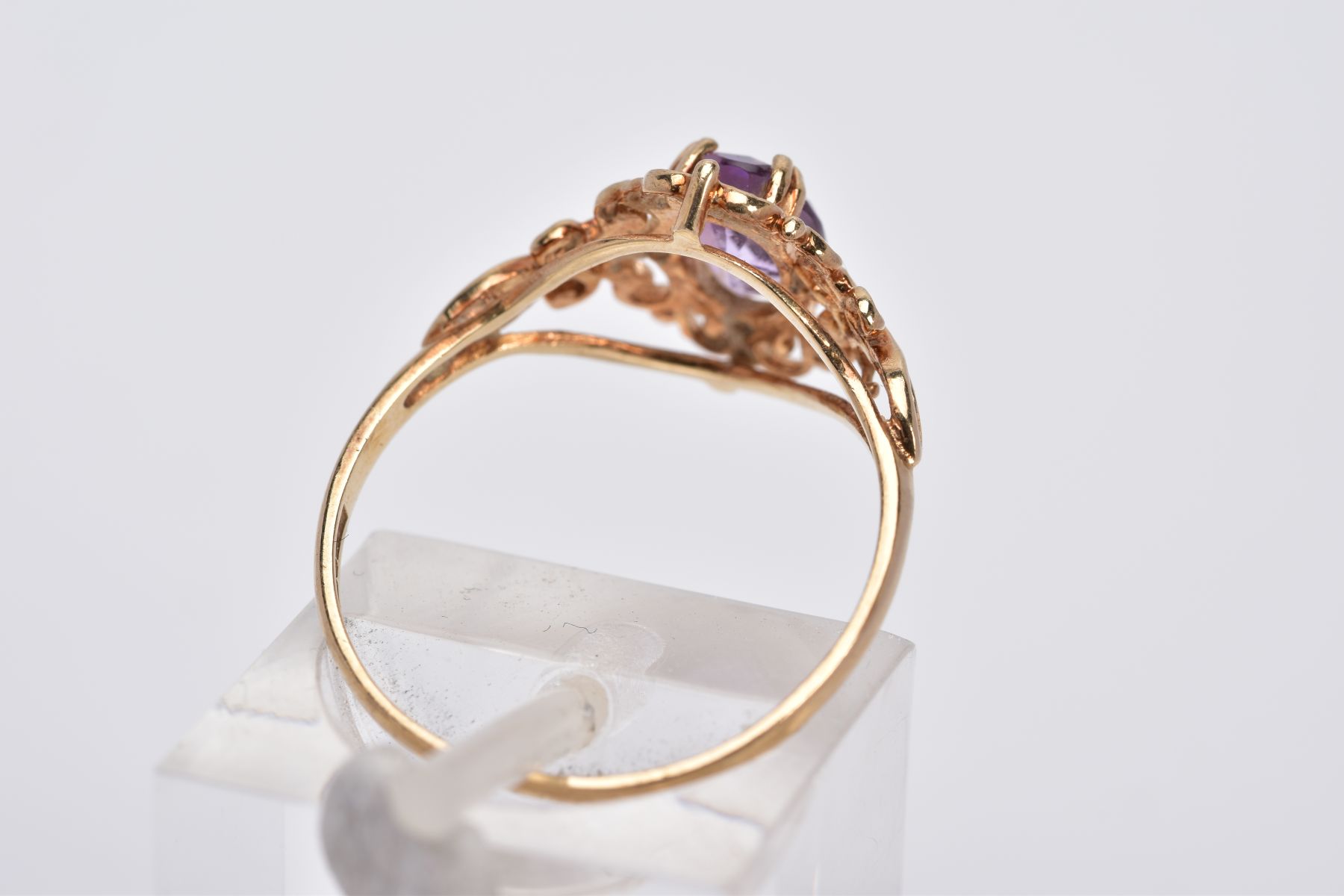 A 9CT GOLD AMETHYST RING, designed with a claw set, oval cut amethyst, within an openwork scroll - Image 3 of 3