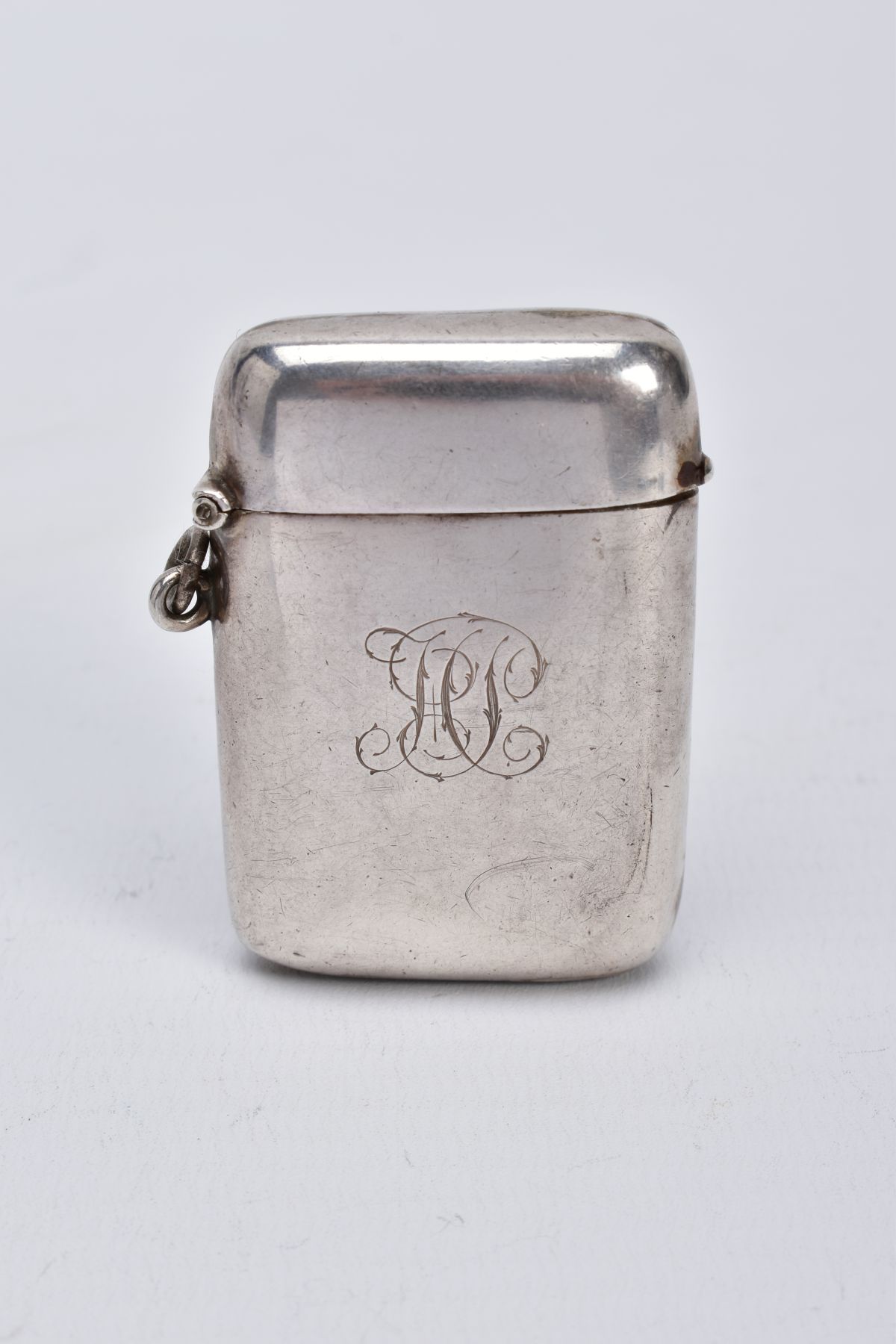 A SILVER VESTA, of a rounded rectangular form, plain polished design with engrave initials to the