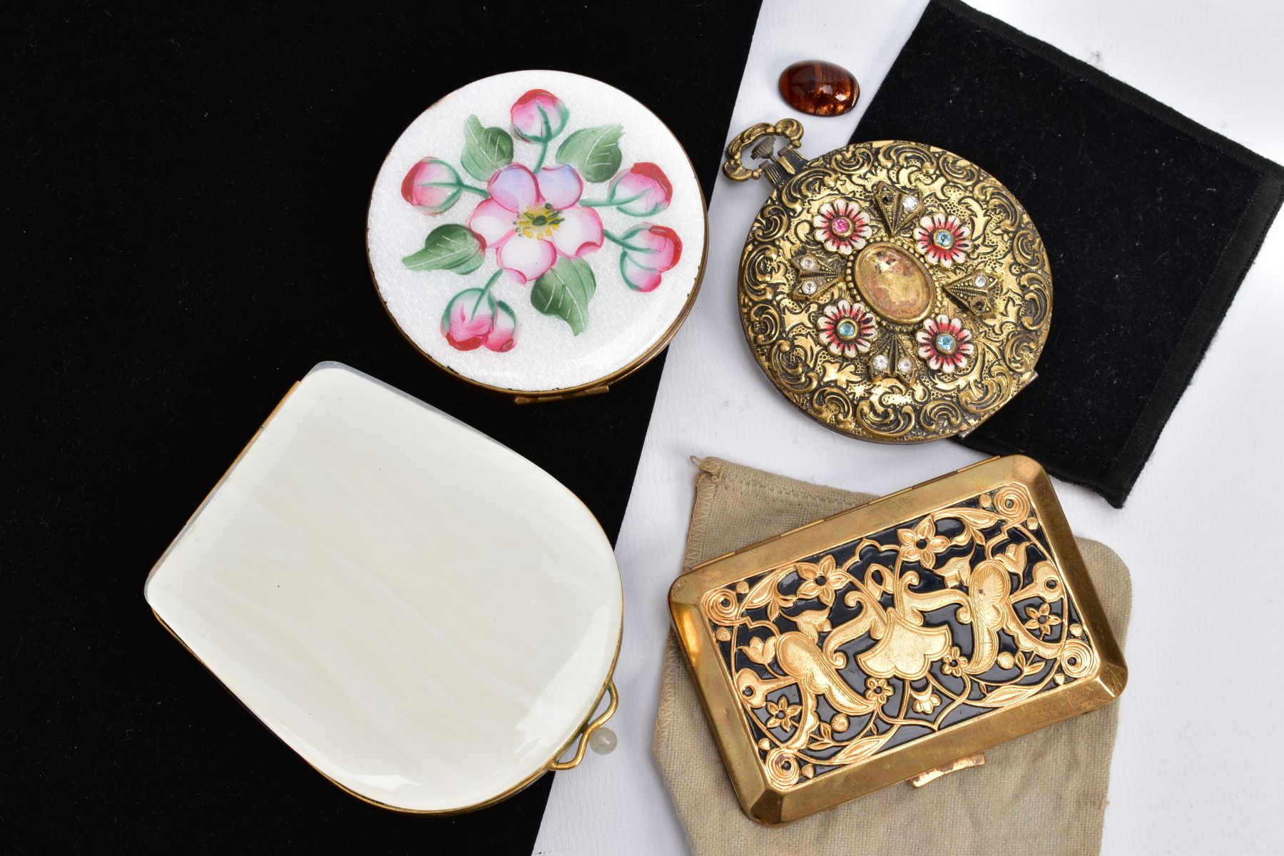 FOUR COMPACTS, to include a circular compact with white guilloche and floral enamel, a white shell