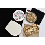 FOUR COMPACTS, to include a circular compact with white guilloche and floral enamel, a white shell