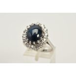 A MODERN 18CT WHITE GOLD LARGE STAR SAPPHIRE AND DIAMOND OVAL CLUSTER RING, star sapphire