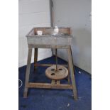 A VINTAGE TREADLE POTTERS WHEEL with an angle iron frame with a tinplate top section, two