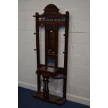 A VICTORIAN FLAME MAHOGANY HALL STAND, with six turned coat hooks, flanking a central mirror and a