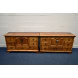 PAIR OF REPRODUCTION OAK SIDEBOARDS, with central double cupboard doors and seven various drawers,