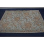 A LAURA ASHLEY RUG, foliate on a lime green field 237cm x 164cm